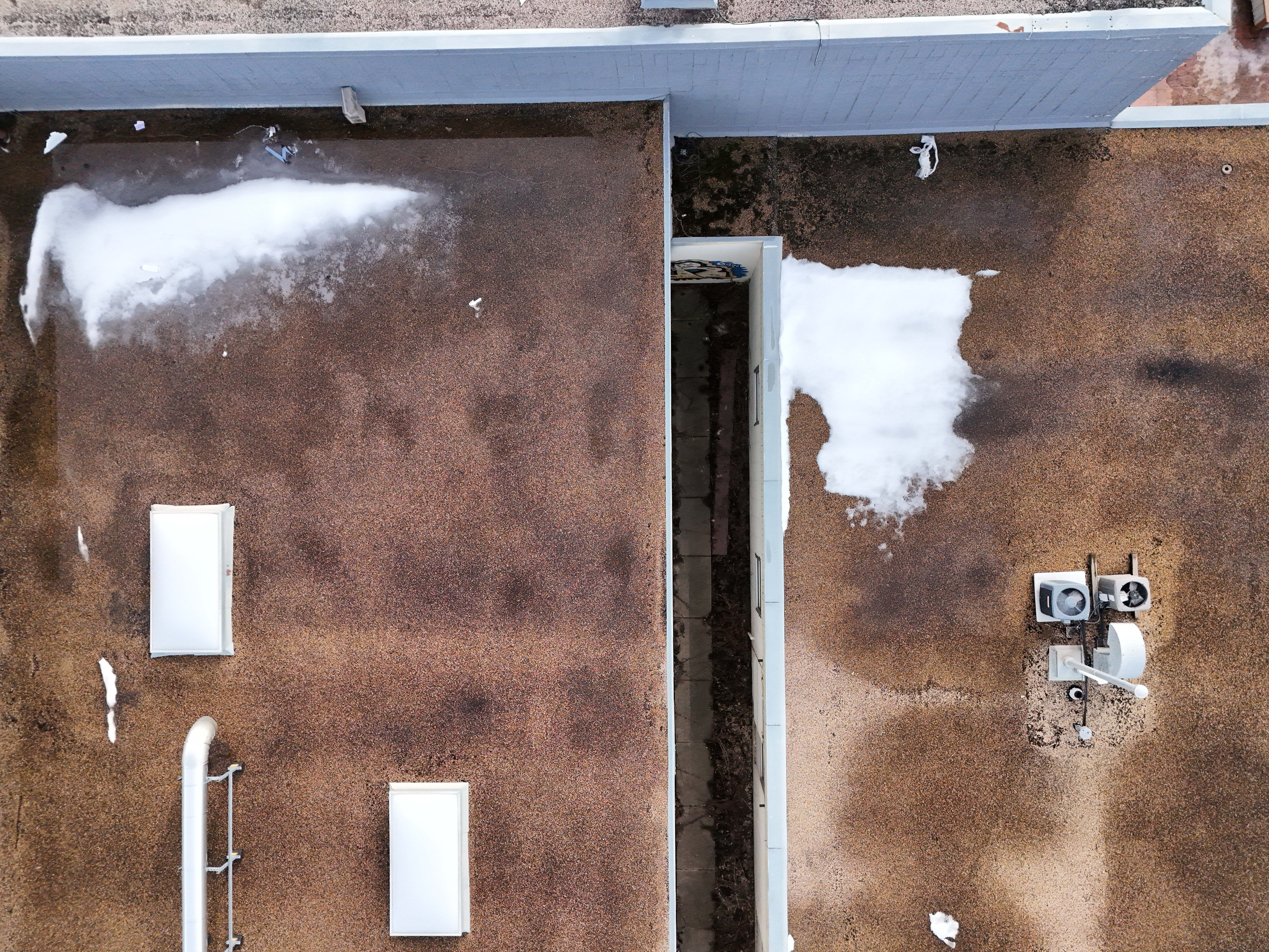 Aerial view of a commercial building roof in Edmonton as during thaw season Alberta winter